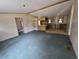 Open-concept living room flowing into the kitchen with neutral walls at 13023 Taylor St, Brooksville, FL 34613
