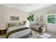 Bright bedroom featuring two beds, a ceiling fan, and a large window that offers natural light at 13203 Lost Key Pl, Lakewood Ranch, FL 34202