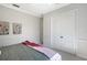 Bedroom featuring a bed with a throw blanket, closet, and white crown molding; neutral colors throughout at 13203 Lost Key Pl, Lakewood Ranch, FL 34202
