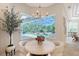 Breakfast nook with a bay window view of the lanai and pool at 13203 Lost Key Pl, Lakewood Ranch, FL 34202