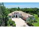 Stunning home featuring a tile roof, three car garage, and beautiful landscaping at 13203 Lost Key Pl, Lakewood Ranch, FL 34202