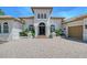 Lovely home boasting an arched front entrance, paver driveway, and three car garage at 13203 Lost Key Pl, Lakewood Ranch, FL 34202