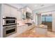 Bright kitchen featuring stainless steel appliances, granite countertops, and white cabinetry at 13203 Lost Key Pl, Lakewood Ranch, FL 34202