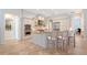 Spacious kitchen with white cabinetry, an island with bar seating, and stainless steel appliances at 13203 Lost Key Pl, Lakewood Ranch, FL 34202