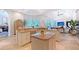 Open kitchen with an island, breakfast bar, granite countertops, and tile flooring at 13203 Lost Key Pl, Lakewood Ranch, FL 34202