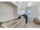 Bright laundry room features ample cabinet storage, large sink and neutral colors at 13203 Lost Key Pl, Lakewood Ranch, FL 34202