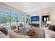 Living room view of the lanai and pool, with decorative rug, comfortable seating, and modern decor at 13203 Lost Key Pl, Lakewood Ranch, FL 34202