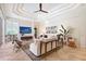 Spacious living room with tray ceiling, recessed lighting, and modern decor at 13203 Lost Key Pl, Lakewood Ranch, FL 34202