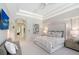 Bright main bedroom featuring a bed, neutral decor, and views to an outdoor living area at 13203 Lost Key Pl, Lakewood Ranch, FL 34202