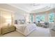 Bright main bedroom featuring a bed, windows, and outdoor views at 13203 Lost Key Pl, Lakewood Ranch, FL 34202