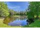 Scenic view of a tranquil pond with lush greenery, creating a peaceful and natural atmosphere at 13203 Lost Key Pl, Lakewood Ranch, FL 34202