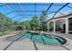 Beautiful pool featuring an attached spa, lush landscaping and covered seating at 13203 Lost Key Pl, Lakewood Ranch, FL 34202