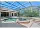 Screened-in pool area with an attached spa and lush landscaping at 13203 Lost Key Pl, Lakewood Ranch, FL 34202