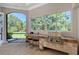 Outdoor summer kitchen with a grill and barstool seating area at 13203 Lost Key Pl, Lakewood Ranch, FL 34202