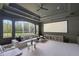 Large theater room with a projector screen, comfortable seating, and a ceiling fan at 13203 Lost Key Pl, Lakewood Ranch, FL 34202