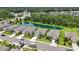 An aerial view of beautiful single-Gathering homes with lush green lawns and a picturesque pond in a serene community at 13804 Woodbridge Ter, Lakewood Ranch, FL 34211