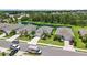 Aerial view of the home with well-manicured landscaping, a driveway, and a pond in the background at 13804 Woodbridge Ter, Lakewood Ranch, FL 34211
