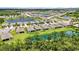 An aerial view showcasing a well-planned community with lush landscaping, serene ponds, and beautifully designed homes at 13804 Woodbridge Ter, Lakewood Ranch, FL 34211