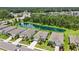 An aerial view of well-maintained homes surrounded by lush landscaping and a tranquil pond, offering a peaceful community setting at 13804 Woodbridge Ter, Lakewood Ranch, FL 34211