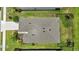 A top-down aerial view of a well-maintained home, showcasing its neat roof, landscaping, and fenced backyard at 13804 Woodbridge Ter, Lakewood Ranch, FL 34211