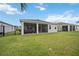 View of the screened patio and fenced backyard with green grass at 13804 Woodbridge Ter, Lakewood Ranch, FL 34211
