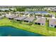 A serene backyard view with a well-kept lawn, a screen, and a community pond offering a relaxing outdoor space at 13804 Woodbridge Ter, Lakewood Ranch, FL 34211