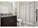 Well-lit bathroom featuring granite counters, a dark vanity, a toilet, and a shower with a curtain at 13804 Woodbridge Ter, Lakewood Ranch, FL 34211