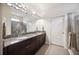 Bathroom with double sink vanity, granite countertops, and glass enclosed shower at 13804 Woodbridge Ter, Lakewood Ranch, FL 34211