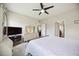 Bedroom with ceiling fan features TV, dresser with mirror, and doorways to other rooms at 13804 Woodbridge Ter, Lakewood Ranch, FL 34211