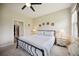 Comfortable bedroom featuring a queen bed, ceiling fan, and neutral color palette at 13804 Woodbridge Ter, Lakewood Ranch, FL 34211