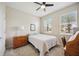 Comfortable bedroom with neutral walls, carpet, ceiling fan and two windows with blinds for privacy at 13804 Woodbridge Ter, Lakewood Ranch, FL 34211