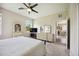 Bedroom showcases a ceiling fan, dresser with mirror, and view to dining room at 13804 Woodbridge Ter, Lakewood Ranch, FL 34211