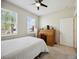 Bright bedroom with carpet, a ceiling fan, a desk, and a window bringing in natural light at 13804 Woodbridge Ter, Lakewood Ranch, FL 34211