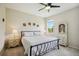 Spacious bedroom featuring carpet, large windows and a dark metal bed frame with white bedding at 13804 Woodbridge Ter, Lakewood Ranch, FL 34211