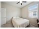 A simple bedroom with carpet, a ceiling fan, one window with blinds and a white comforter at 13804 Woodbridge Ter, Lakewood Ranch, FL 34211