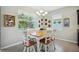 Bright dining area with a wooden table, white chairs, decorative plates and plenty of natural light at 13804 Woodbridge Ter, Lakewood Ranch, FL 34211