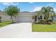 Charming home with a well manicured lawn and colorful landscaping at 13804 Woodbridge Ter, Lakewood Ranch, FL 34211