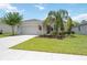 Charming home with a well manicured lawn and colorful landscaping at 13804 Woodbridge Ter, Lakewood Ranch, FL 34211