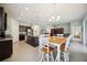 Open kitchen and breakfast area, granite counters, stainless appliances and backyard views at 13804 Woodbridge Ter, Lakewood Ranch, FL 34211