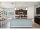 A kitchen with an island, dark cabinetry, granite countertops, and stainless steel appliances at 13804 Woodbridge Ter, Lakewood Ranch, FL 34211