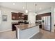 A kitchen boasts stainless appliances, granite counters, an island, and wood cabinets at 13804 Woodbridge Ter, Lakewood Ranch, FL 34211