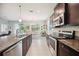 A kitchen with island, stainless appliances and an adjacent breakfast area with backyard access at 13804 Woodbridge Ter, Lakewood Ranch, FL 34211