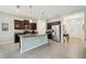 A kitchen featuring granite countertops, an island, stainless steel appliances, and dark wood cabinets at 13804 Woodbridge Ter, Lakewood Ranch, FL 34211