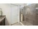 Modern walk-in shower with tile surround, glass enclosure, and brushed nickel hardware at 13804 Woodbridge Ter, Lakewood Ranch, FL 34211