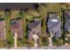 An aerial shot of homes and their yards, some featuring screened-in pools and a pond at 14901 17Th E Ave, Bradenton, FL 34212