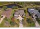 An aerial view of homes and their yards, some featuring screened-in pools and ponds at 14901 17Th E Ave, Bradenton, FL 34212