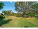Beautiful backyard with a mature tree line, a black fence, and tranquil waterfront views, offering privacy and space at 14901 17Th E Ave, Bradenton, FL 34212