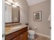 Powder room with granite vanity and framed art at 14901 17Th E Ave, Bradenton, FL 34212