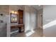 Bathroom vanity with storage and a mirror, next to the closet and access to the hall at 14901 17Th E Ave, Bradenton, FL 34212