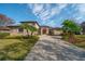 Inviting home boasting lush landscaping, a grand entrance, a long driveway, and a well-maintained lawn at 14901 17Th E Ave, Bradenton, FL 34212